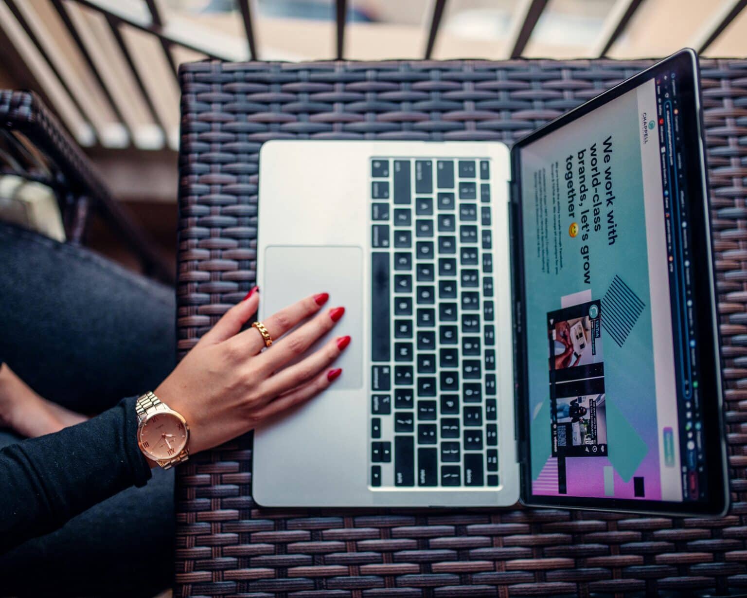 woman using laptop on outdoor table